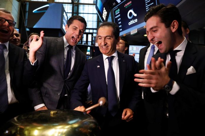 Patrick Drahi, founder and controlling shareholder of the the telecommunications group Altice rings a ceremonial bell marking the IPO of the company on the New York Stock Exchange shortly after the opening bell in New York